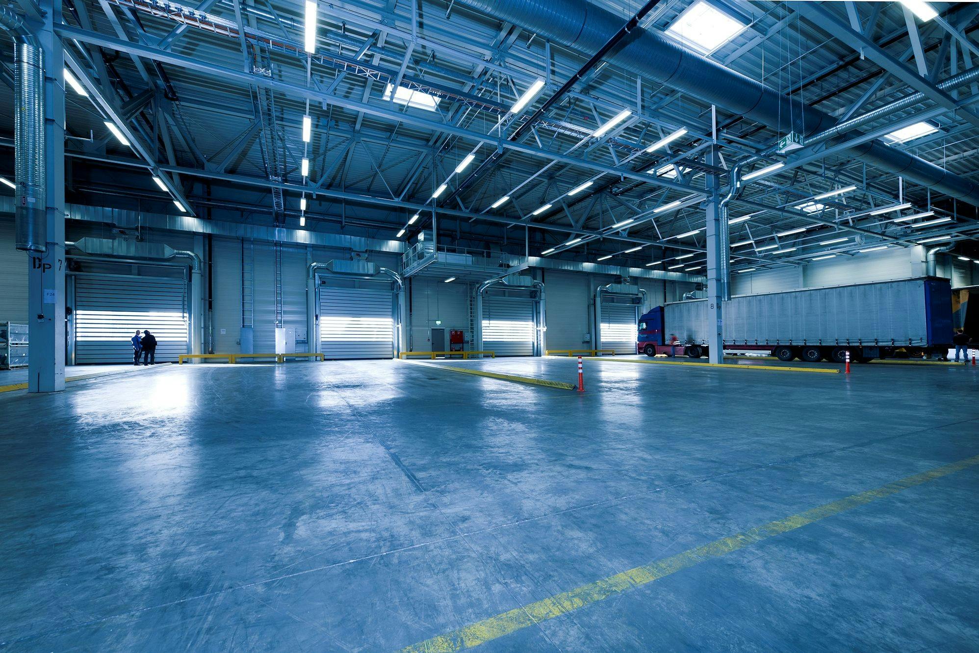 service-1 Large warehouse interior with docked truck, ideal for logistics and warehousing.