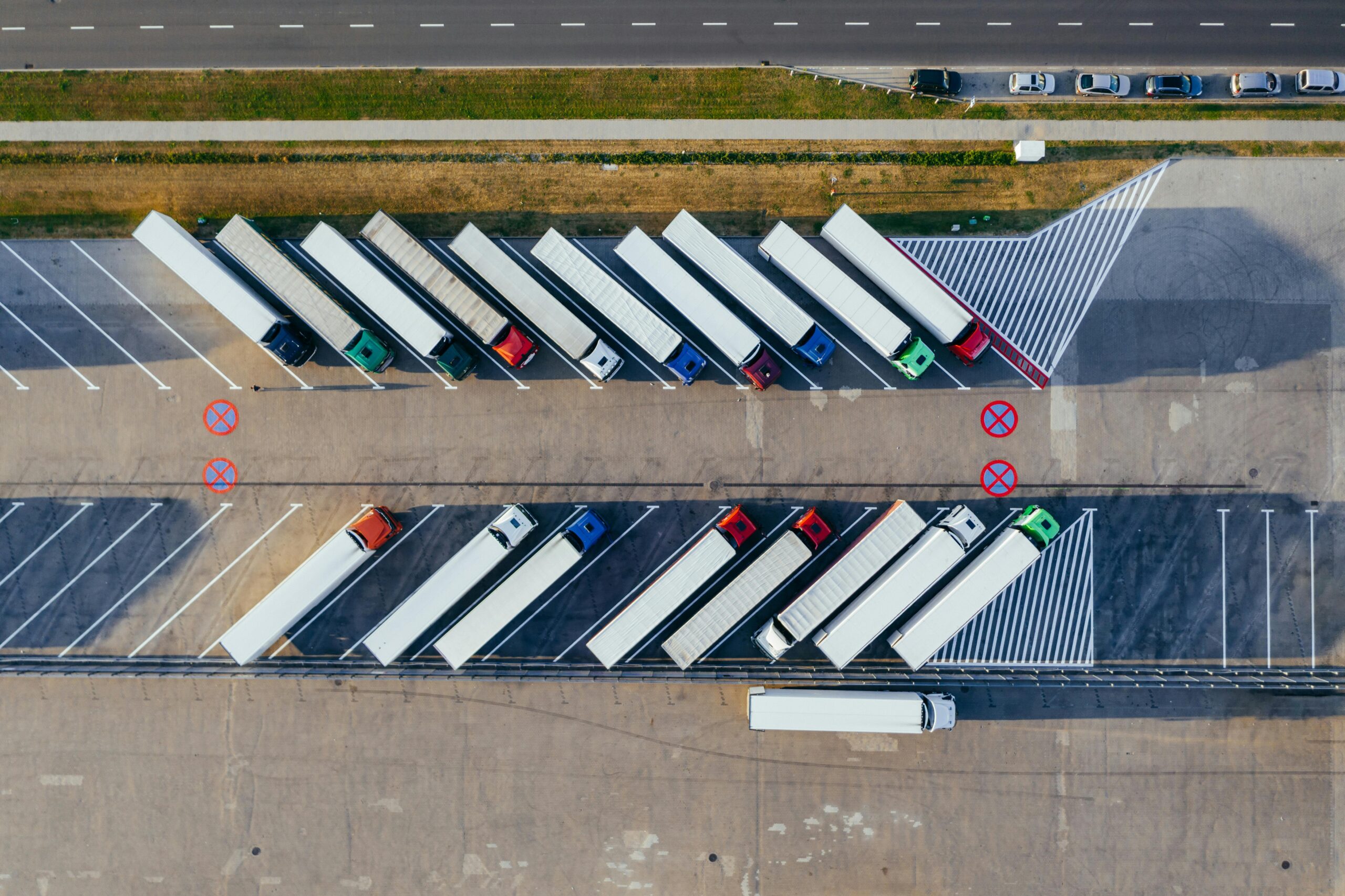 service-1 Overhead shot of semi-trucks parked in Poznań, Poland, demonstrating transportation logistics.